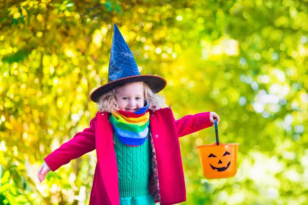 Little girl in witch costume at Halloween