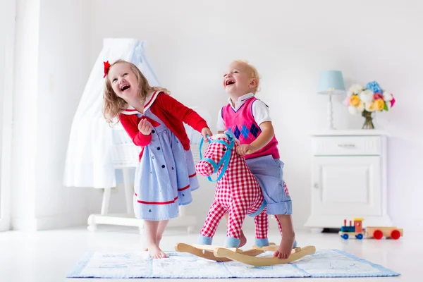 Kids playing with rocking horse