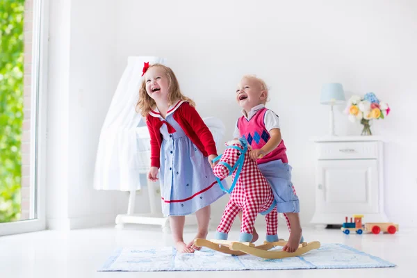 Kids playing with rocking horse