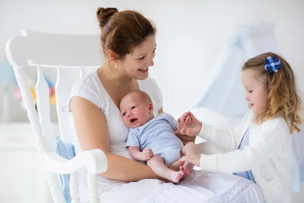 Mother with newborn baby and toddler daughter