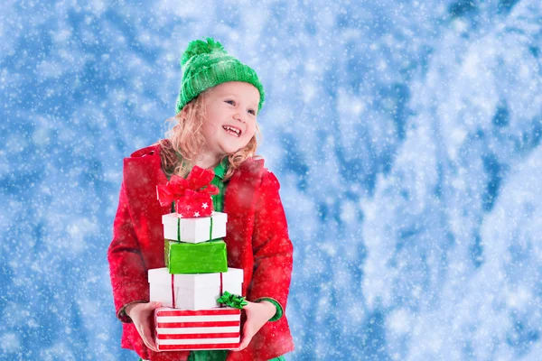 Little girl holding Christmas presents