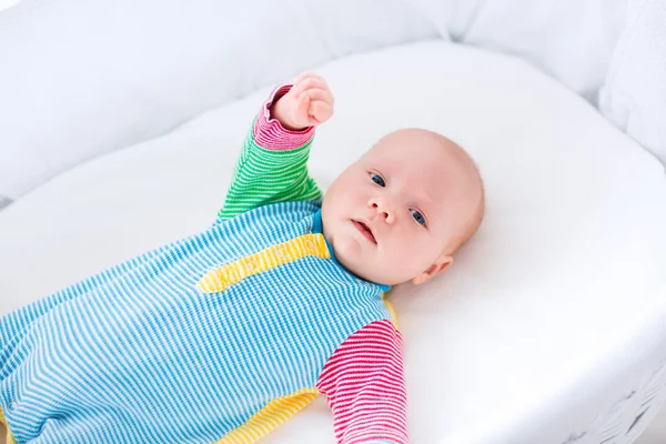 Cute baby boy in a white crib