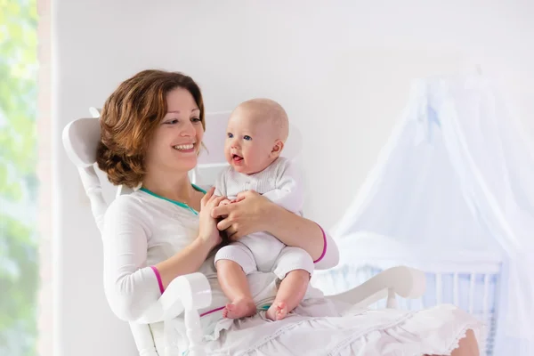 Mother and baby in white bedroom