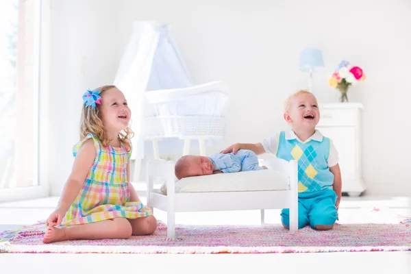 Little boy and girl meet new sibling