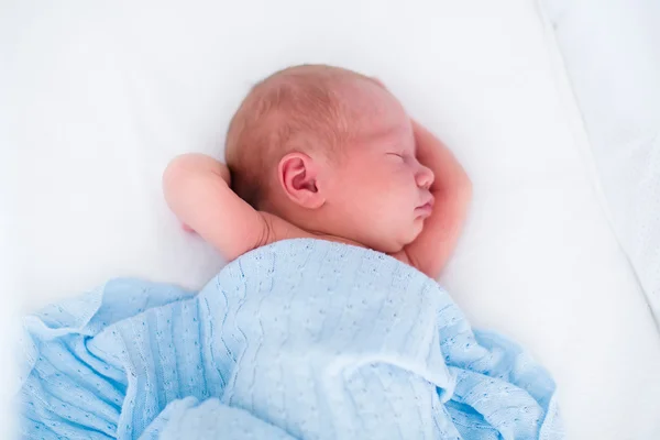 Cute newborn baby in white bed