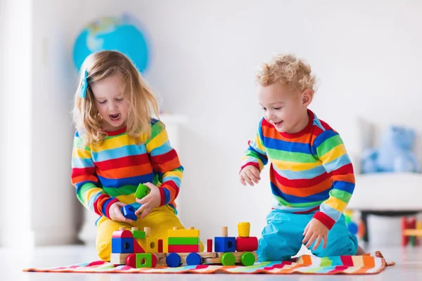 Kids playing with wooden toy train