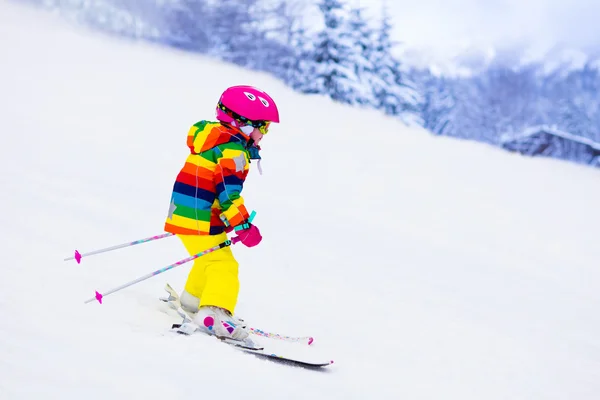 Little girl skiing in the mountains