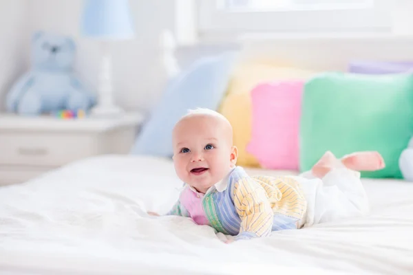 Cute baby on white bed