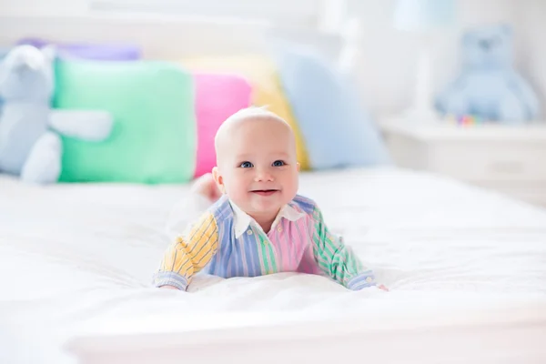 Cute baby on white bed
