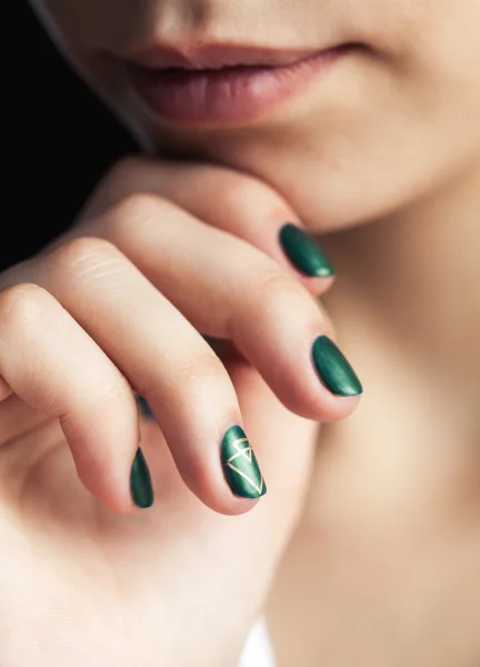 Beautiful modern fashionable girl with a green manicure. Nails style, gel.