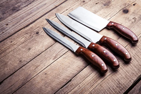 Beautiful knives with wooden handle, on an old table. Kitchen, c