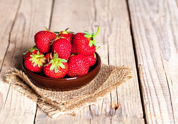 Fruit. Fresh strawberries on old wooden background