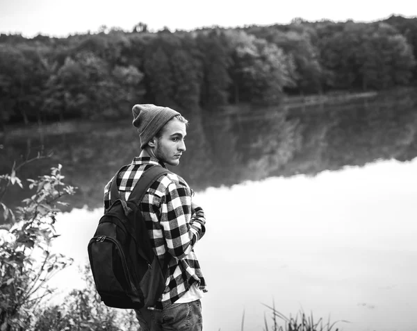 Young Man standing alone outdoor Travel Lifestyle concept with lake