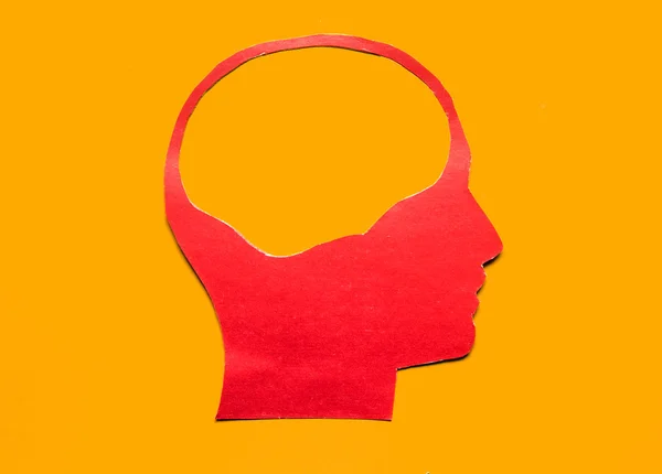 Red paper human head with hollow space