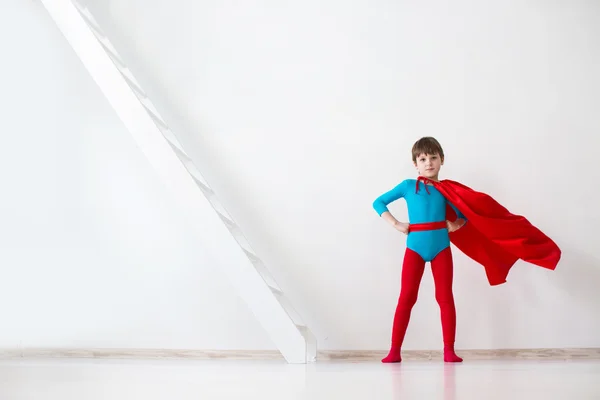 Leader. The boy super hero in a red cloak.