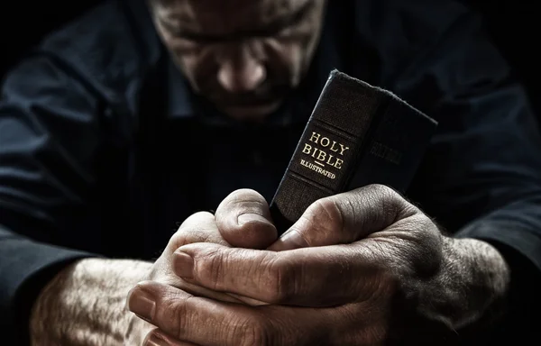 Man holding a Holy Bible