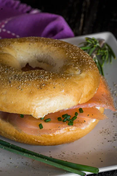 With a smoked salmon bagel and cream cheese