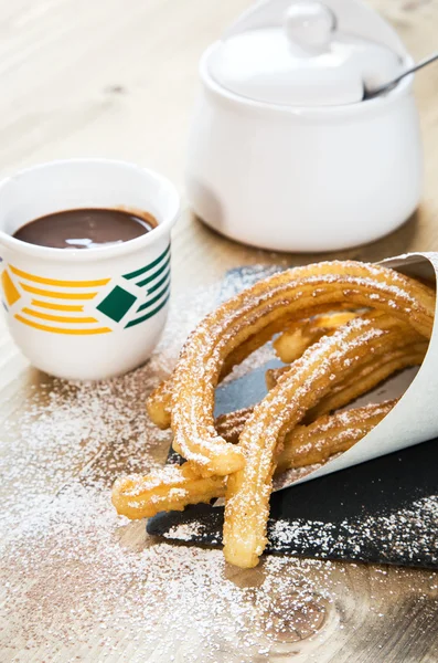 Churros with hot chocolate and sugar