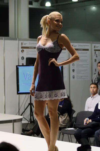 5th International Exhibition of underwear, beachwear, home wear and hosiery Lingrie Expo Moscow Aututumn September Young blonde woman in a purple negligee