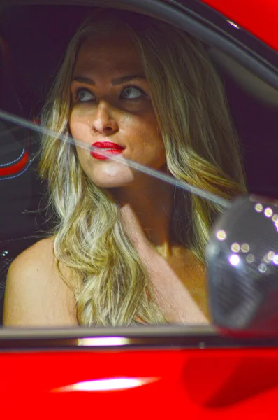 Red Maserati Moscow International Automobile Salon Young blonde woman in the passenger compartment