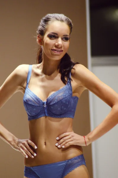 Young woman in a blue bikini Lingrie Expo Moscow Autumn