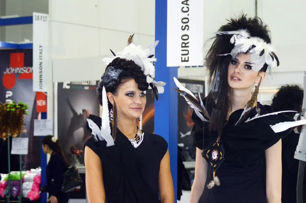 Intercharm XXI International Perfumery and Cosmetics Exhibition Two young beautiful womans in black dress Sexy