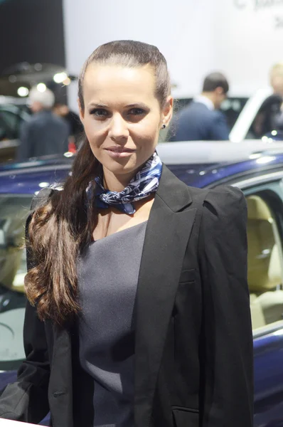 A young woman from the team BMW near car. BMW 316i Moscow International Automobile Salon Dark Blue