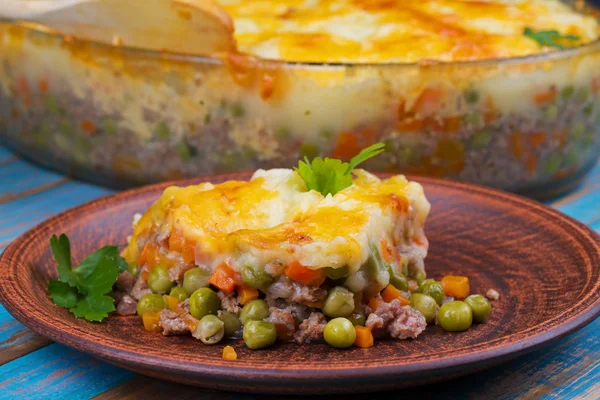 Potato, cheese, meat, carrot, onion and green peas casserole