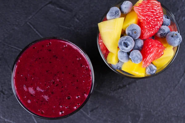Mango, grapefruit and blueberry smoothie. Fresh fruit salad. Slices of fruits.  View from above, top studio shot