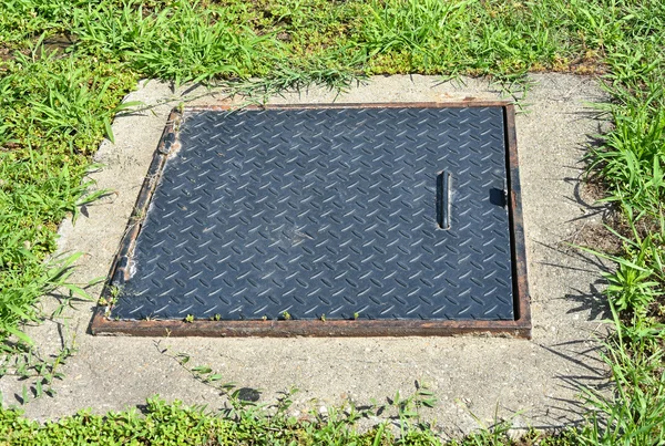 Manhole cover in the grass area