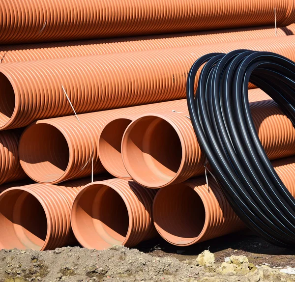 Plastic pipes and cables at the road construction