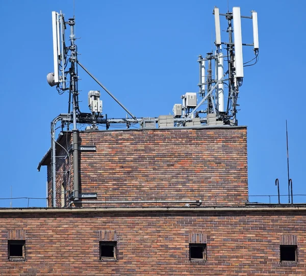 Antennas on the top of an old warehouse building