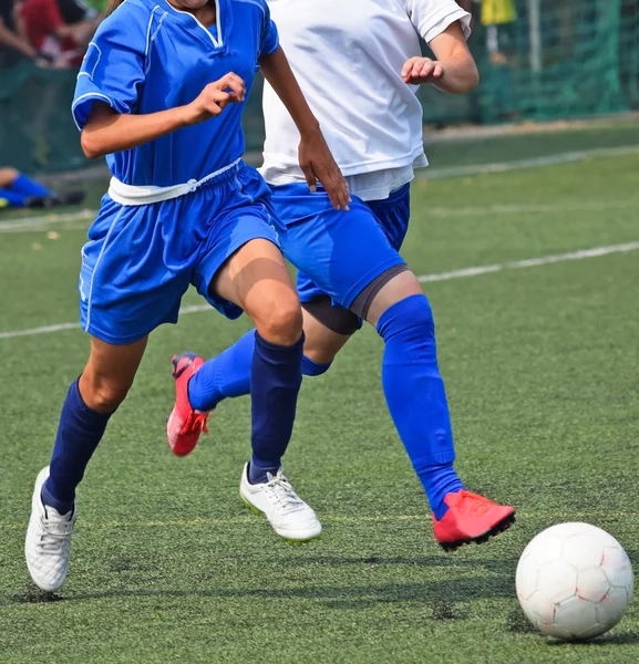 Young women play soccer