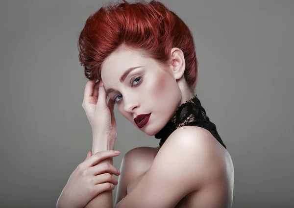 Beauty stylish redhead woman with necklace jewelry in studio