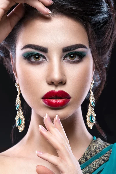 Beautiful brunette girl with arabic evening make-up and perfect skin. Beauty face. Close up