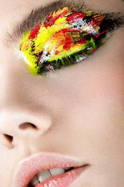 Colorful make-up on close-up eye. Art beauty image.