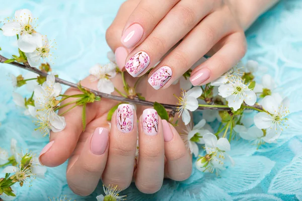 Spring manicure for the bride in gentle tones with flowers. Nail Design. Close-up.