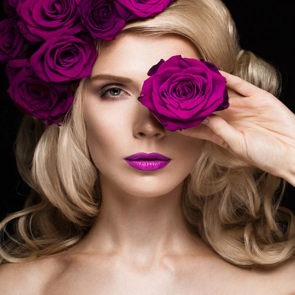 Beautiful blond girl in dress and hat with roses, classic makeup, curls, red lips. Beauty face.