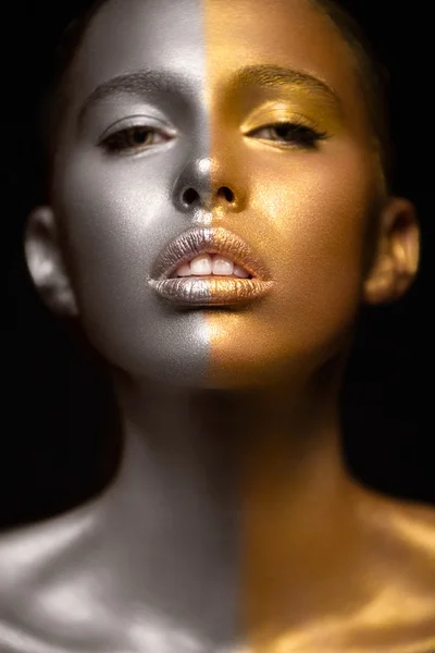 Girl with gold and silver skin in the image of an Oscar. Art image beauty face.