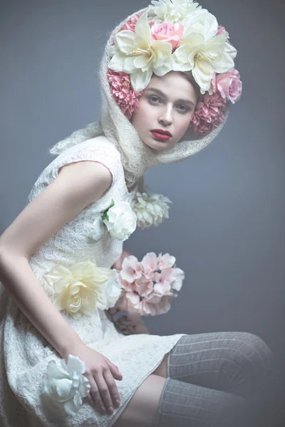 Girl with flowers on her head in a dress in the Russian style. Fog effect.