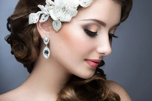Portrait of a beautiful woman in a wedding dress in the image of the bride. Beauty face