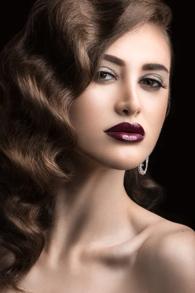 Beautiful woman with evening make-up, burgundy lips and curls. Beauty face.