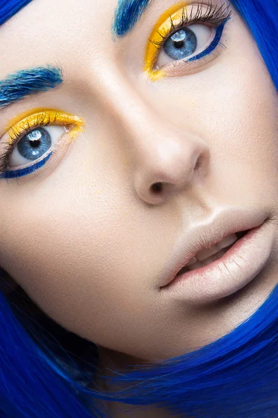 Beautiful girl in a bright blue wig in the style of cosplay and creative makeup. Beauty face. Art image.