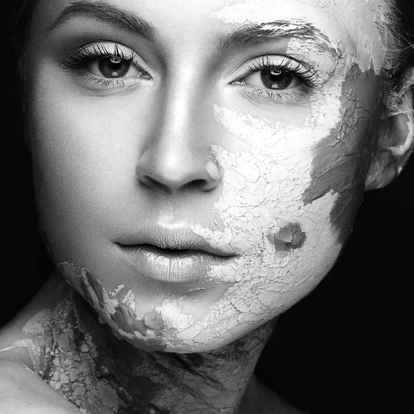 Beautiful girl with mud on his face. Cosmetic mask. Beauty face.  Black&white photo
