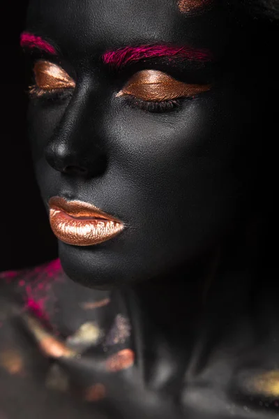 Fashion portrait of a dark-skinned girl with color make-up. Beauty face.