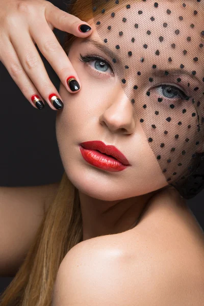 Beautiful girl with a veil, evening makeup, black and red nails. Design manicure. Beauty face.