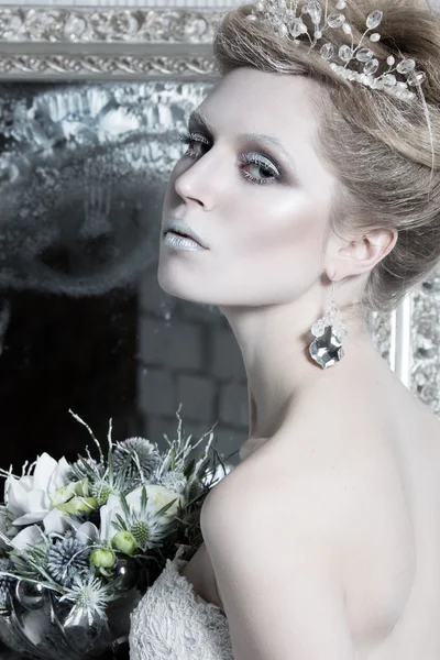 Beautiful girl, white dress in image of the Snow Queen with a crown on her head.