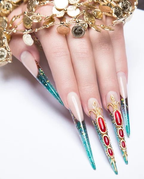 Long beautiful manicure on the fingers of turquoise and red. Nails design. Isolate object. Close-up