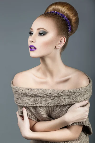Beautiful red-haired girl with purple lips, smooth hair and an ornament in the head. Beauty face.