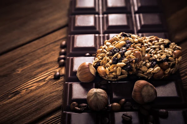 Roasted coffee beans, chocolate and muesli on the wooden background